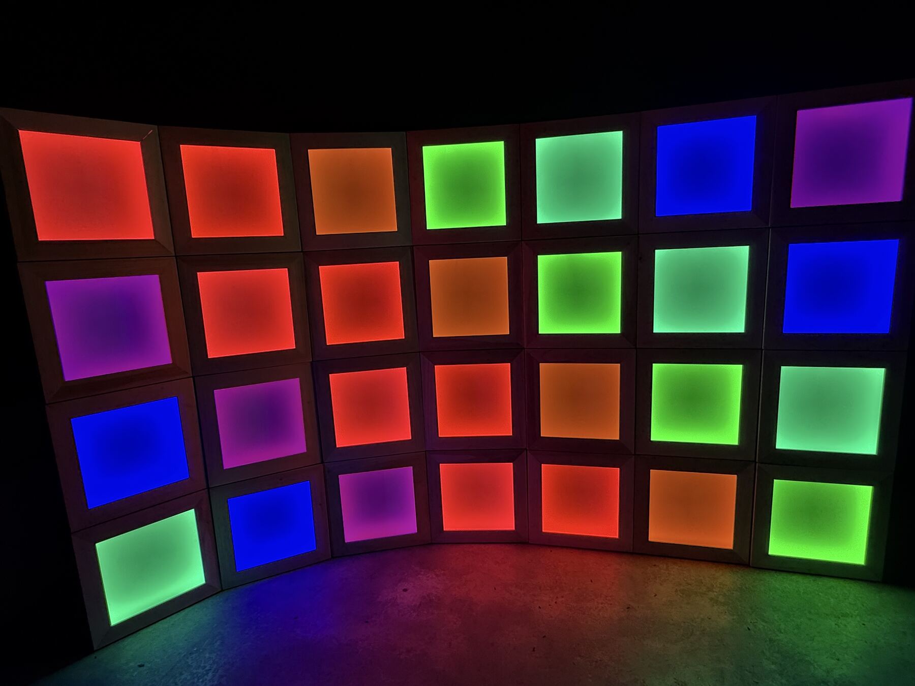 Chromaclipse Matrix: a curved wall of light boxes in columns of red, orange, green, mint and blue
