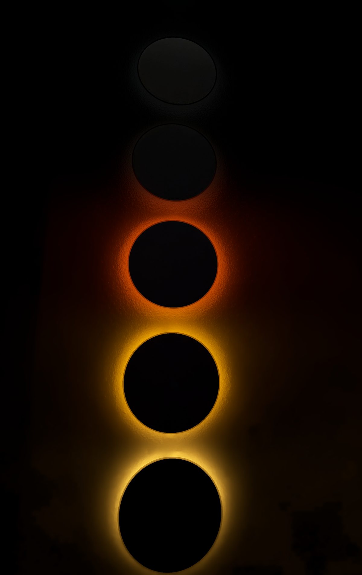 Pentaclipse sunrise: the light climbs to the middle disc, red above amber