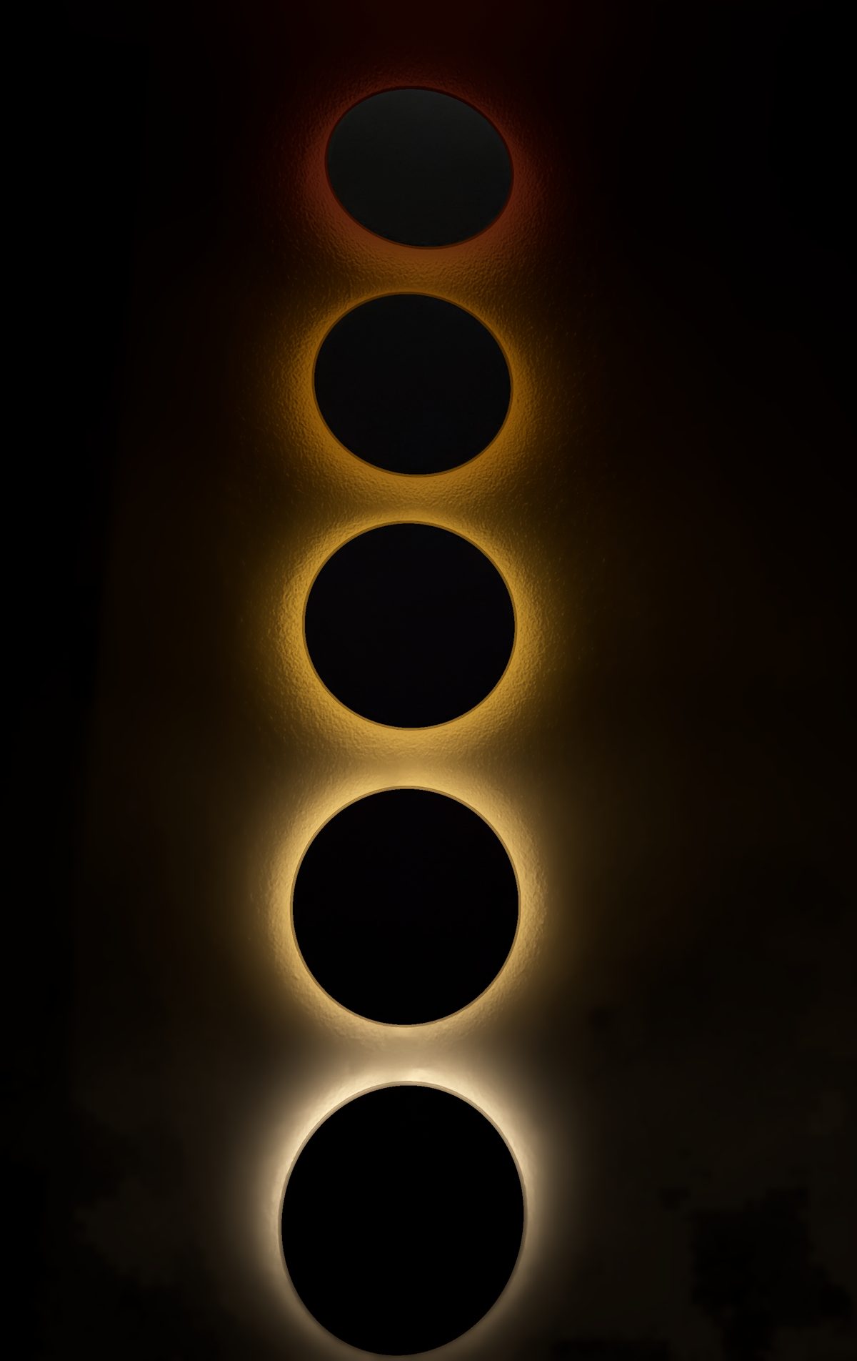 Pentaclipse sunrise, halfway: all five discs lit, red at the top to warm white at the bottom